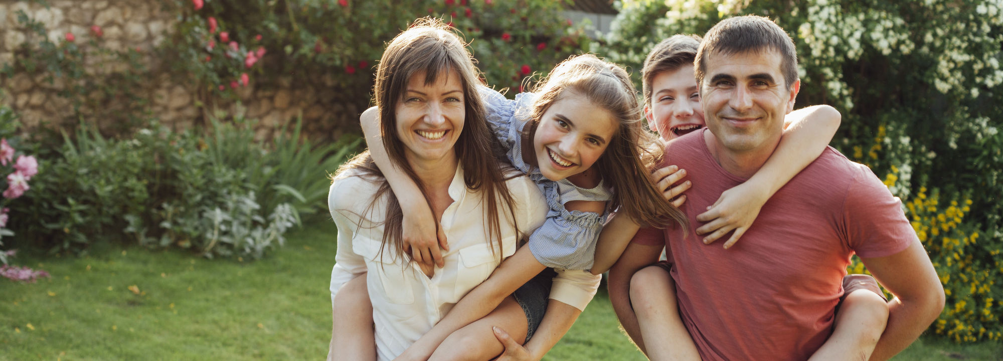 Family smiling in their backyard